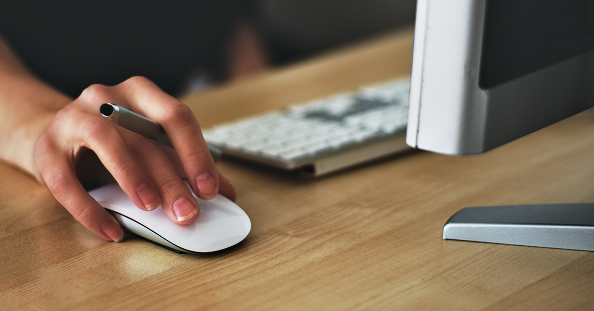 a close-up of a hand operating a computer mouse